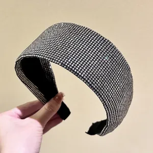 Macro detail of high-end wide headband featuring sparkling rhinestones on black fabric
