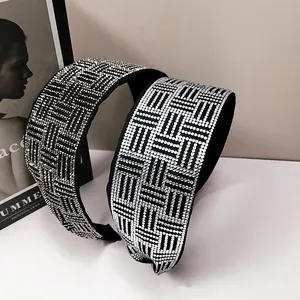 Detailed view of wide black headbands with silver rhinestones in a geometric woven pattern