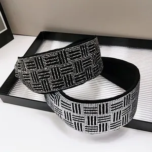 Close-up of sparkling rhinestone headbands with geometric grid patterns on wide bands