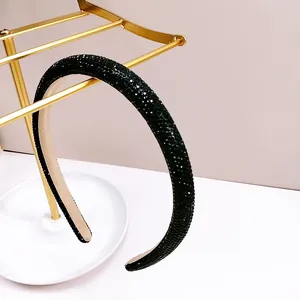 Detailed close-up of premium black rhinestone headband with comfortable inner velvet lining