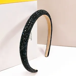 Detailed view of high-density rhinestone headband with sparkling texture and beige lining