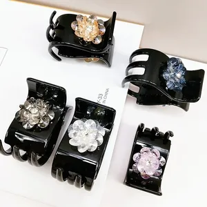 Detail of five-piece set of crystal flower hair clips with strong grip in various colors