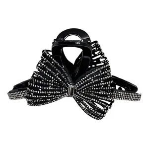 Elegante molletta per capelli a fiocco nero con strass argentati e grande cristallo