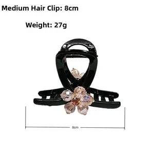 Detail of medium hair claw clip with 8cm length and sparkling crystal flowers