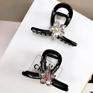 Elegant black hair claw clips with sparkling crystal flowers in purple and clear set of two