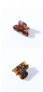 Gros plan sur la petite pince à cheveux en acétate avec motif écaille de tortue ambrée