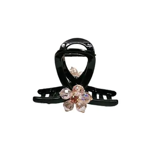 Elegant black shark hair claw with champagne crystal flower for women's hairstyle
