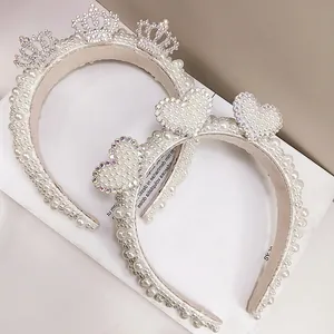 Detailed close-up of pearl headbands with crown and heart motifs for bridal party wear