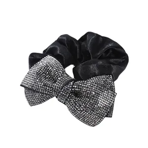 Elegant black satin scrunchie featuring a large bow with sparkling silver rhinestones