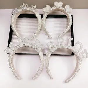 Elegant white pearl headbands set with crown, heart, and BRIDE lettering for weddings