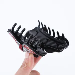 French rhinestone bow hair claw with colorful crystals on black high-gloss plastic base