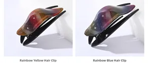Close-up of glitter swallowtail hair clips in rainbow yellow and blue gradient finishes