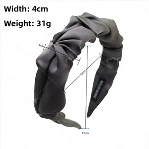 Detail view of 4cm wide dark grey pleated satin headband with handmade label and dimensions