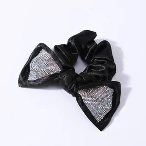 Elegant black satin scrunchie featuring a large bow embellished with sparkling rhinestones