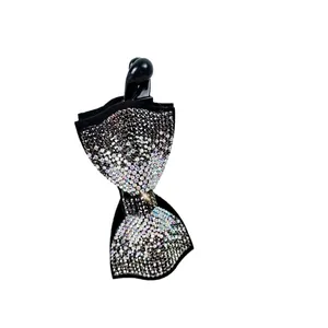 Elegant banana clip hair accessory featuring a luxurious rhinestone bow and black base