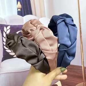 Elegant satin knotted headbands in brown, champagne pink, and navy blue with pleated texture