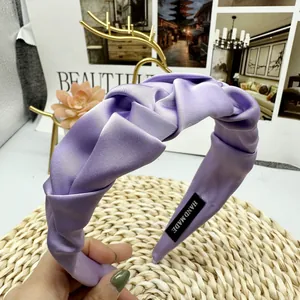 Detailed macro view of handmade lavender satin headband with pleated texture and silk finish
