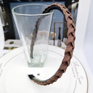 Detailed view of dark brown braided headband with non-slip teeth on inner band
