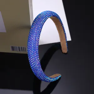 Detail of wide sparkling rhinestone headband with navy blue base and aurora crystals