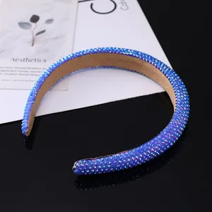 Close-up of wide blue sponge headband with sparkling rhinestones and soft suede lining