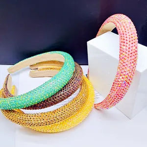 Detailed close-up of thick sponge headbands fully covered with sparkling colorful rhinestones