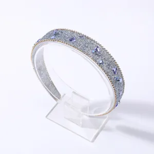 Detalle de diadema barroca ancha con gemas moradas y cristales plateados brillantes