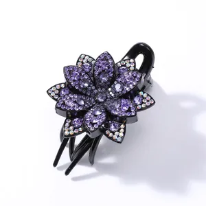 Detailed macro view of purple rhinestone flower hair claw with sparkling crystals