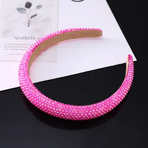 Detailed macro view of bright pink sparkling rhinestone headband with soft velvet inner lining