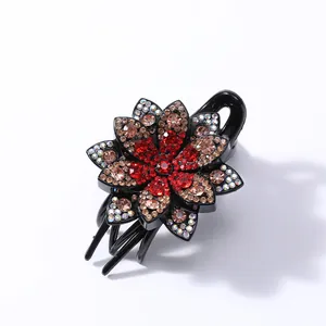 Detailed close-up of a three-tier floral claw clip with vibrant red and colorful rhinestones
