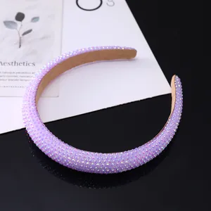 Close-up of elegant purple rhinestone headband with premium velvet lining texture