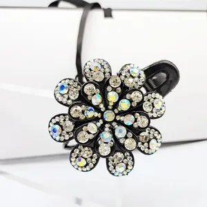 Detailed macro view of black resin flower hair claw with crystal rhinestone petals