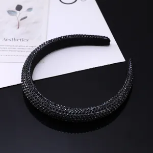 Macro shot of black sponge headband with glittering rhinestones and elegant reflection