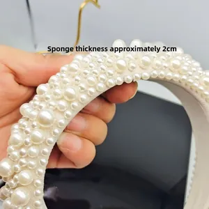 Detail shot showing 2cm thick sponge headband with dense white pearl embellishments