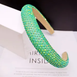 Detail of emerald green padded headband with shimmering rhinestones and anti-slip lining