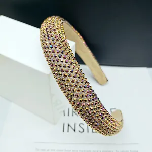 Close-up of a padded wide headband with colorful gradient rhinestones and luxury finish