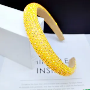 Close-up of yellow rhinestone padded headband with sparkling crystal pave setting