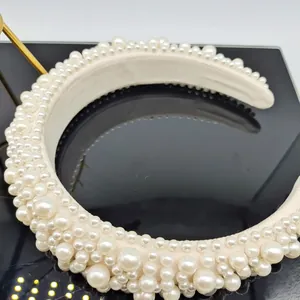 Detail showing white faux pearls of varying sizes on an ivory baroque sponge headband