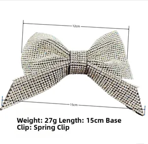 Detail of a large bow hair clip with sparkling rhinestones, 15cm length with spring clip