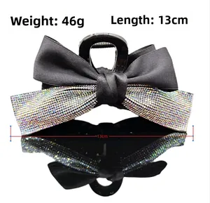 Detail view of large bow hair claw clip with rhinestones, length 13cm and weight 46g