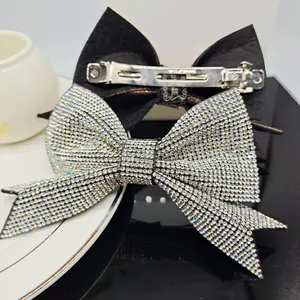 Elegant bow hair clip set with sparkling rhinestones and durable silver metal spring clip