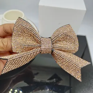 Macro shot of large rhinestone bow hair clip showing sparkling crystals and spring design