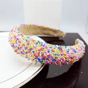 Detailed close-up of rainbow sponge headband with colorful sprinkles and 3D candy beads