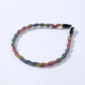 Close-up of rainbow rhinestone headband with twisted design and protective black ends