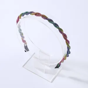 Macro detail of rainbow rhinestone headband featuring double twisted rope design with gems