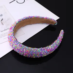 Macro shot of wide hairband featuring colorful sugar-like glitter beads and soft khaki lining