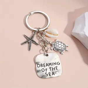 Silver ocean keychain with starfish turtle shell pendants and Dreaming of the Sea charm