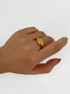 Detailed view of an 18K gold plated evil eye signet ring with a clear zircon stone