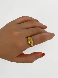 Detail of gold plated stainless steel ring with evil eye zircon inlay on model hand