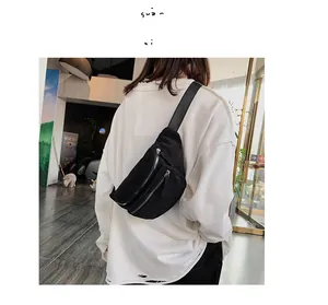 Street style shot of a black corduroy chest bag worn across the body by a model