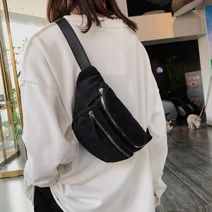 Women's black corduroy chest bag featuring dual zippers and adjustable strap in crossbody style
